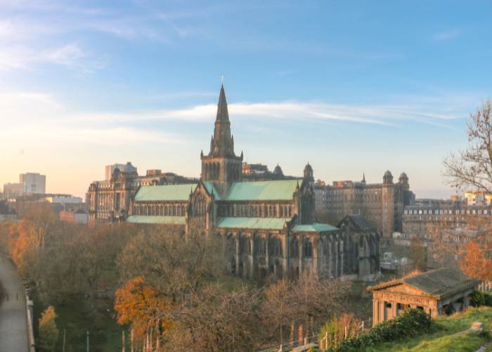 Glasgow Cathedral, Scotland, bathed in the light of sunset with its autumnal colors