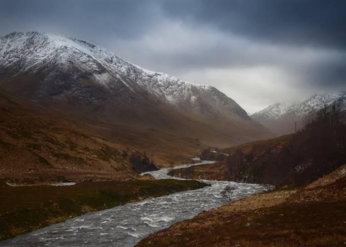 River Etive dressed in its autumn colors, winding through picturesque Glen Etive in the Scottish Highlands