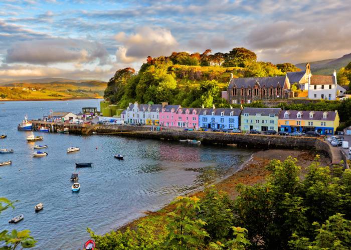 View of Portree, the largest town on the Isle of Skye in Scotland, with its summer sunset.