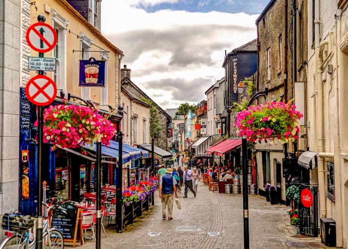 Bustling High Street in Kilkenny, Ireland. Kilkenny is a historic town known for its medieval architecture and iconic castle on the banks of the River Nore.