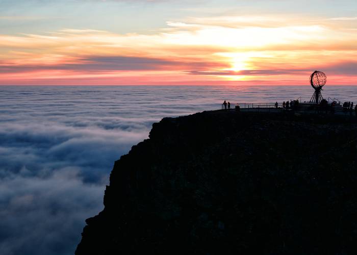 Panoramic view of the North Cape platform in Norway, overlooking the Arctic Ocean covered by a vast cloud layer.