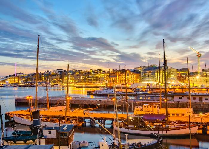 Panoramic view of Oslo harbor at sunset, Norway's capital, with its modern and historic buildings lining the Oslo fjord in the North Sea.