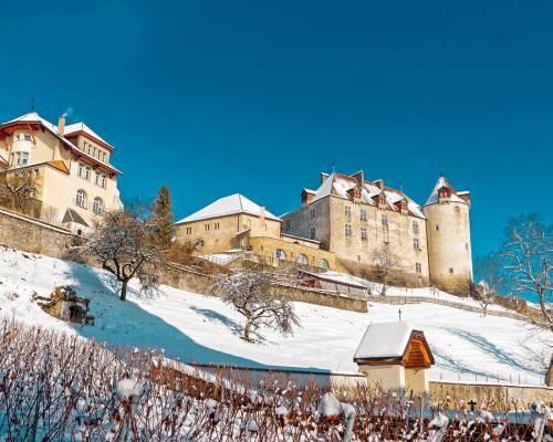 Château de Gruyères in Switzerland, perched on a green hill in the heart of the Fribourg Pre-Alps, surrounded by alpine landscapes and picturesque villages