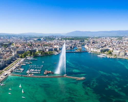 View of the city of Geneva in Switzerland, located on the shores of Lake Geneva, surrounded by the Alps and Jura mountains, and the famous fountain of Lake Geneva