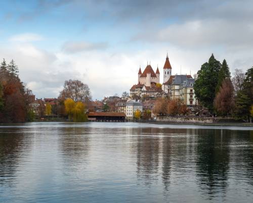 View of Lake Thun with Thun Castle, Thun town church (Stadtkirche) and the River Aar - Thun, Switzerland