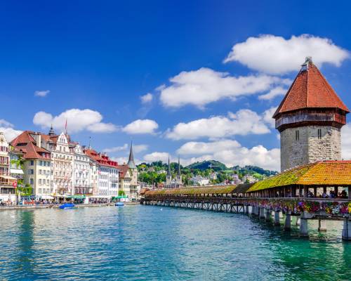 Emblematic view of the Kapellbrücke (Chapel Bridge) in Lucerne, Switzerland. The covered bridge crosses the River Reuss. You can see the picturesque buildings of the city center