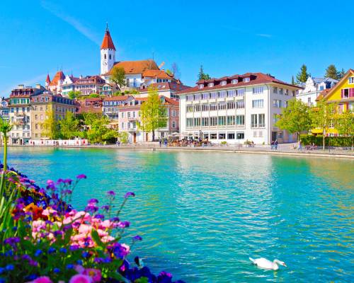 Spring view of Thun with the River Aare, medieval castle and church. The town is located on Lake Thun in the Bernese Oberland, Switzerland